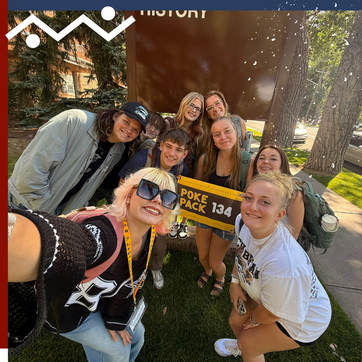 A Poke Pack Leader poses with a group of students at Saddle Up