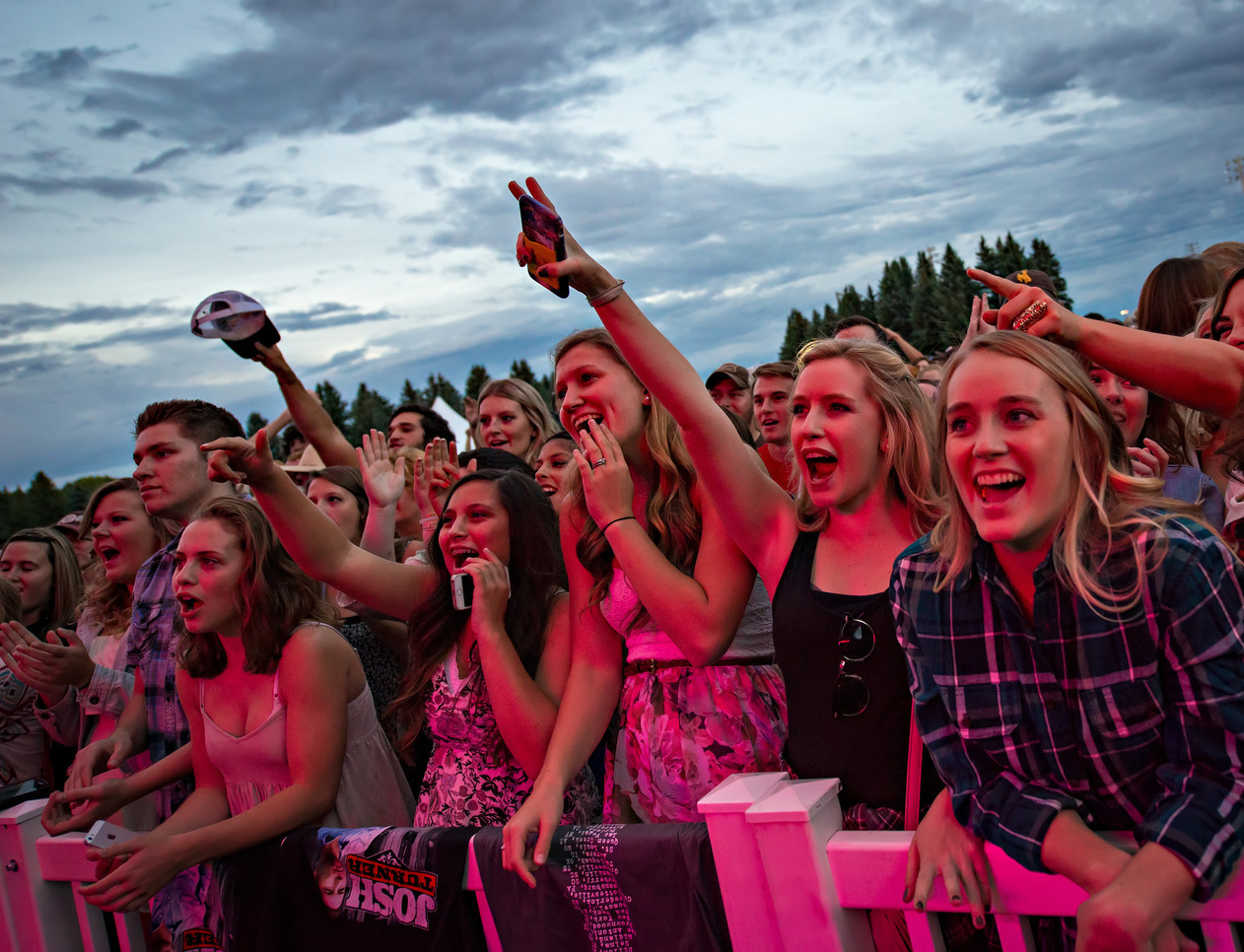 Students cheer in the front row of a concert