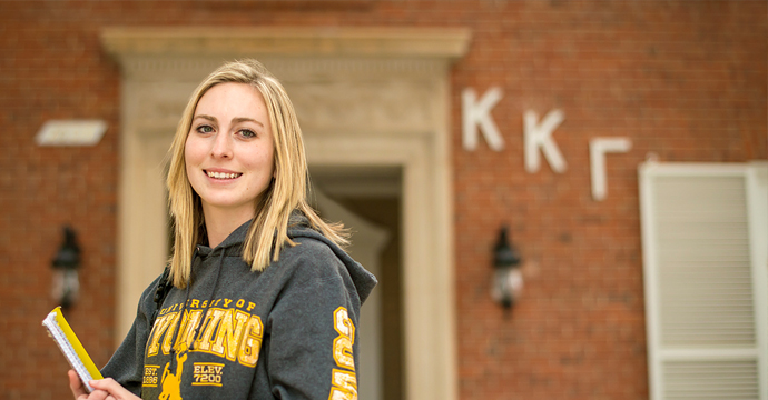 Student in front of sorority house