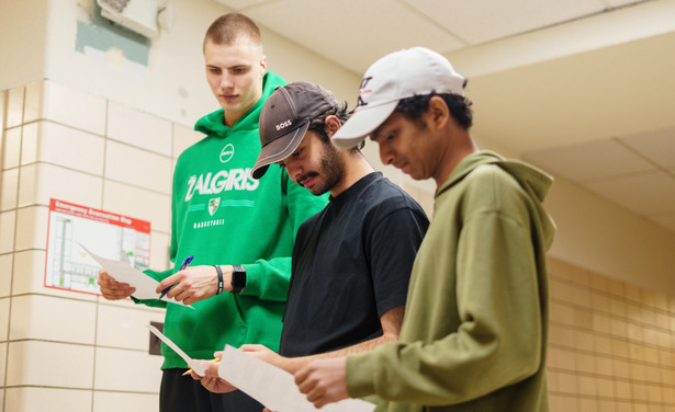 three students reviewing student media content
