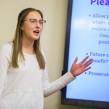 Student presenting in front of a class