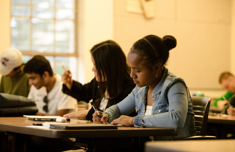 Students taking notes in a classroom