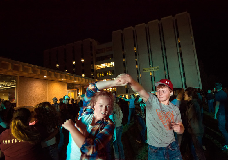 students swing dancing outside of the legacy residence halls