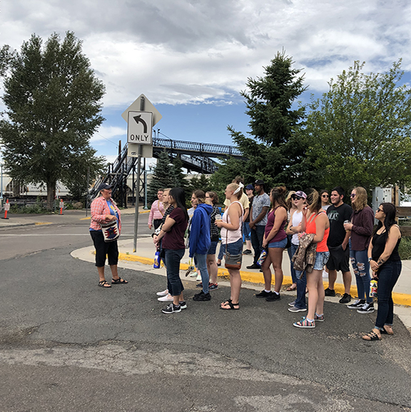 students attend an artist talk of the Laramie Downtown Murals during 2019 Summer Bridge