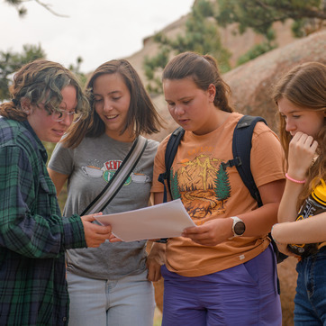 four students check instructions for an activity in Vedauwoo