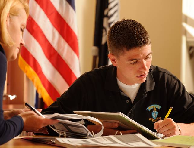 Veteran Student filling out a form at a desk