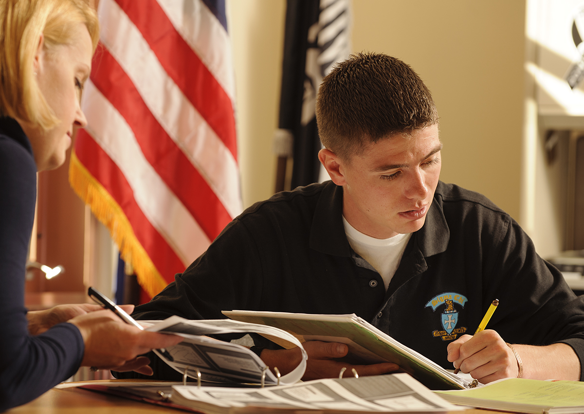 A Veteran student fills out paperwork