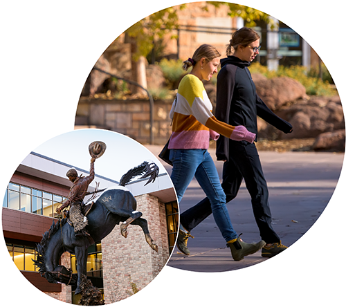 Students walking and a bucking horse statue