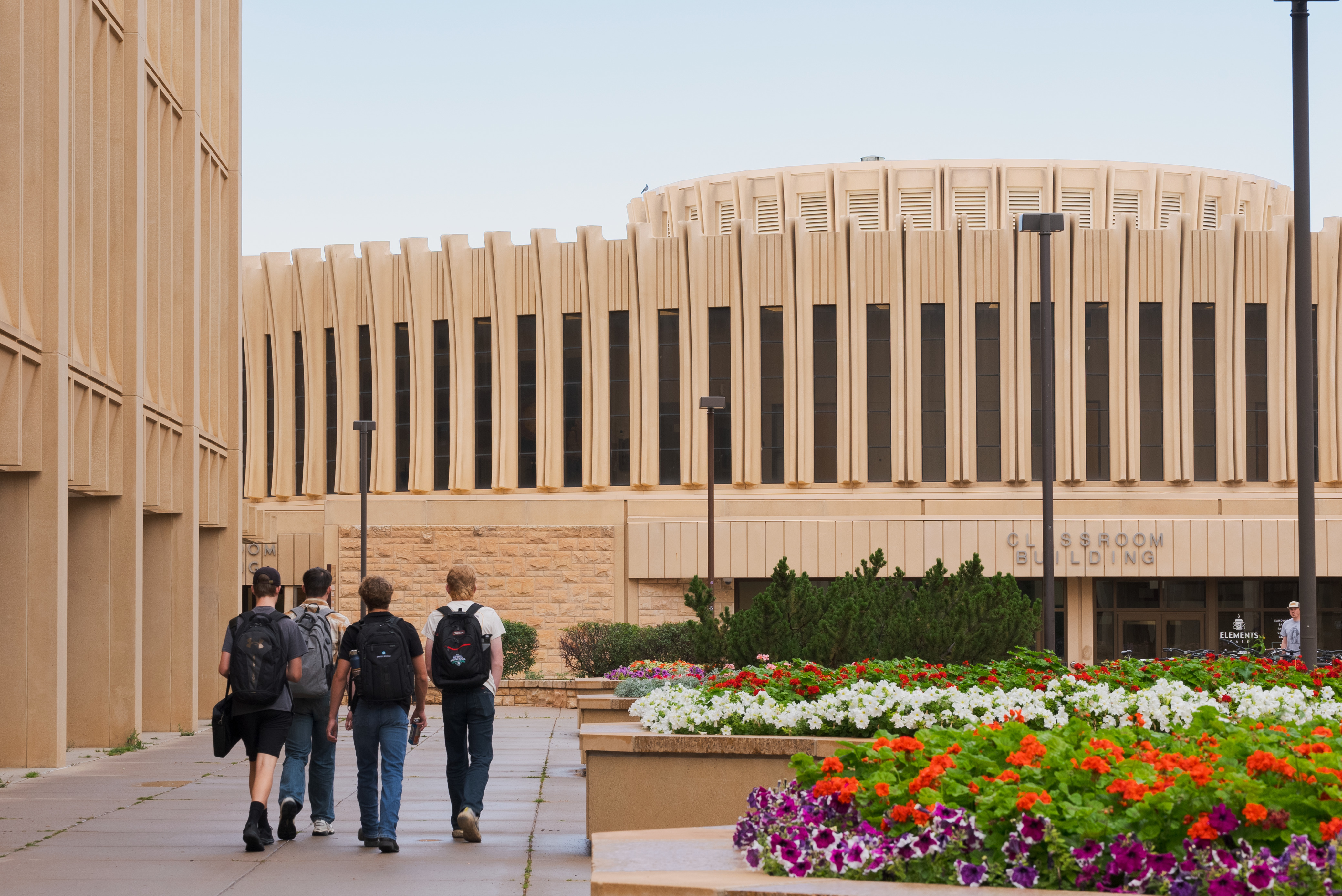 Students walking in front of the Classroom Building
