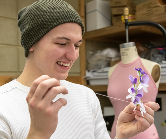 Student working in the costume shop