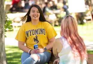 Two students talk on campus