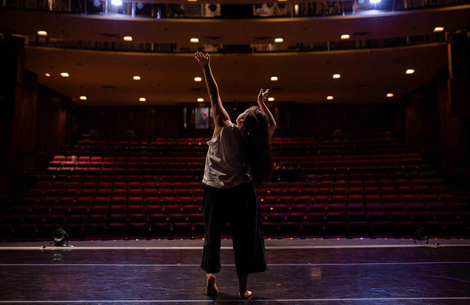 Woman on stage with dimmed lights