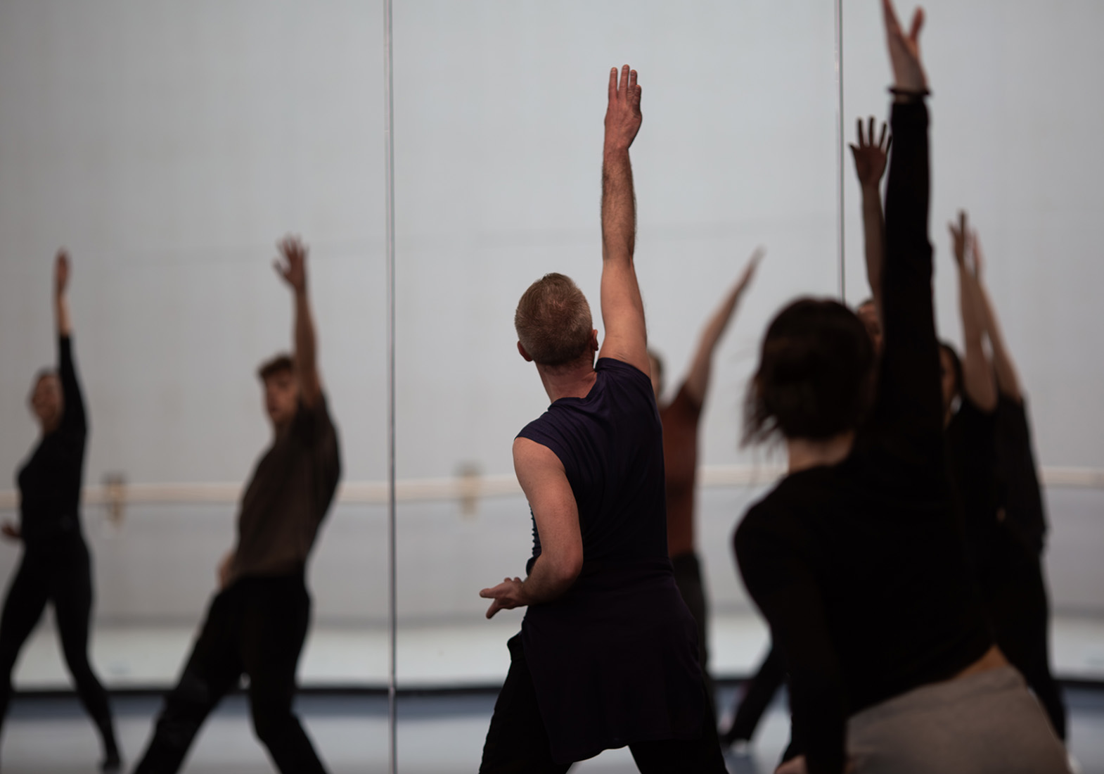 Members practicing dance facing a mirror