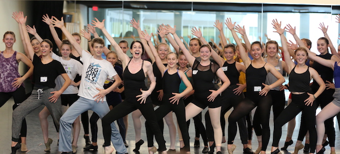 Enthusiastic students posing with Carol Schuberg