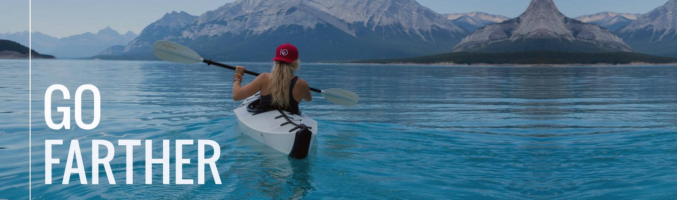 Female on kayak in mountain lake