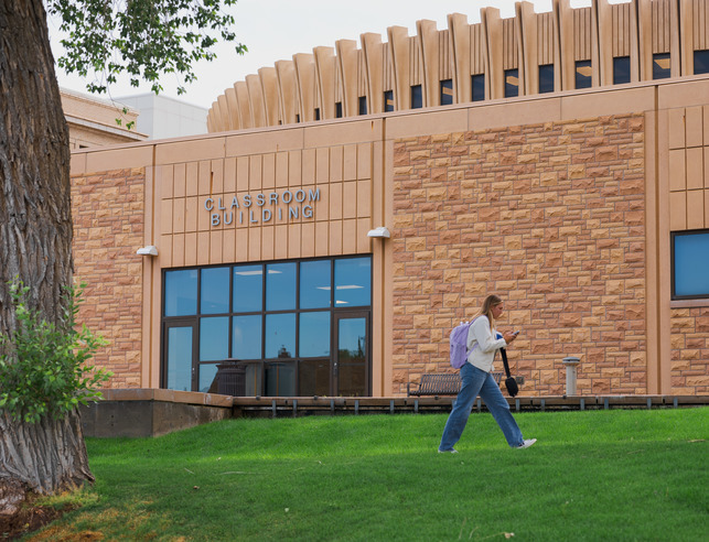 student walks in front of the UW classroom building