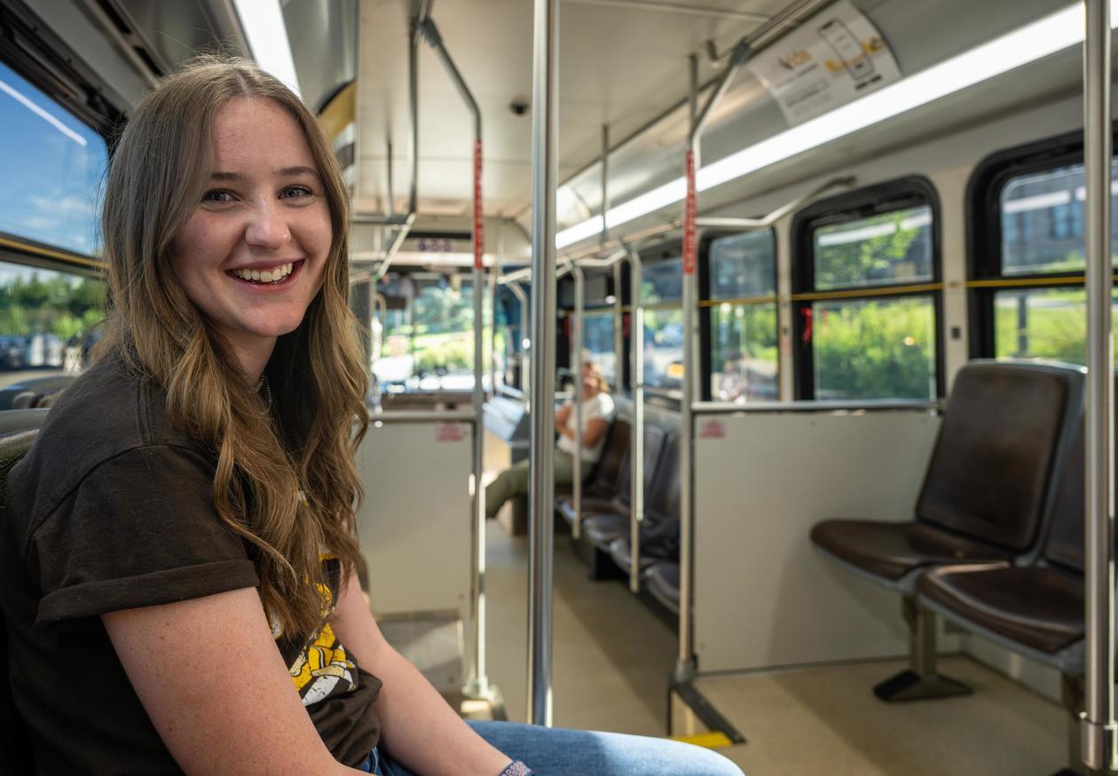A UW student riding a UWYO Roundup shuttle.