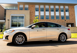 A UW rental vehicle is parked on the University of Wyoming campus