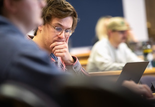 A University of Wyoming student look at their computer in a class.