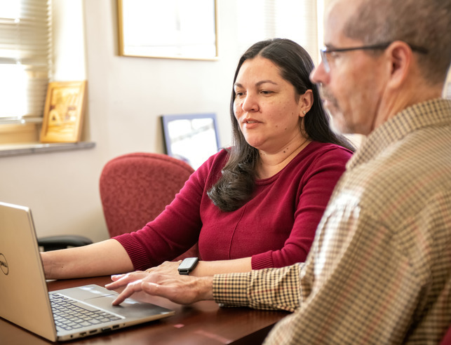 Two people looking at computer