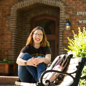Student sitting on bench 