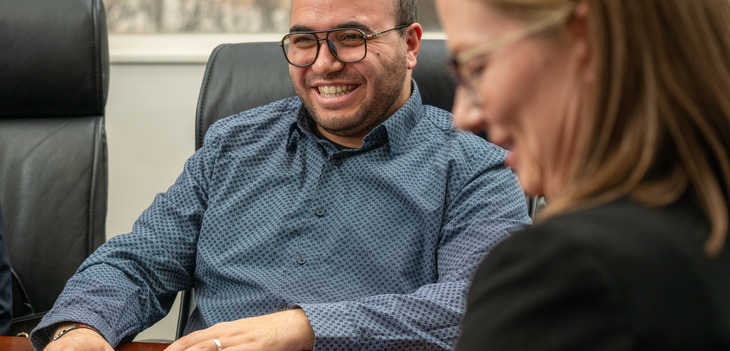 A faculty member smiling 