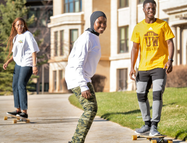 Students skateboarding on campus