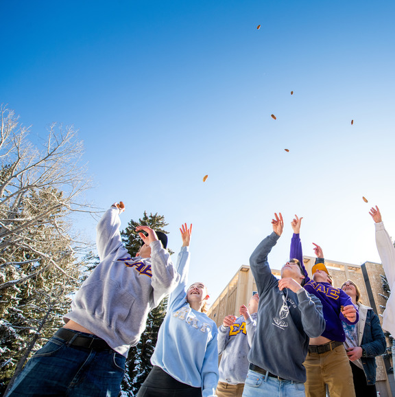 Students jumping with their arms up
