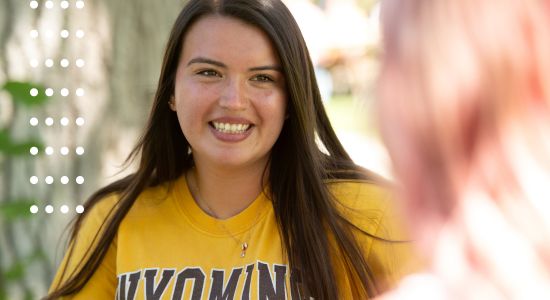 a student smiling at the camera