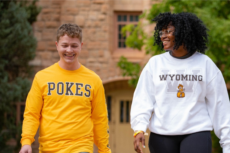 image of students walking in wears from the university store