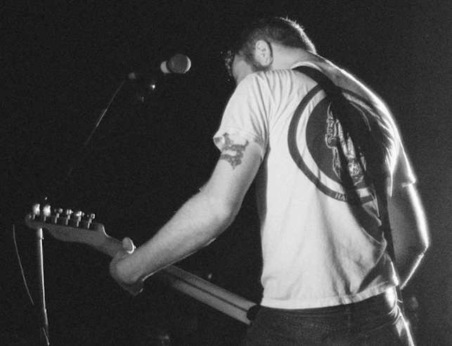 Man playing guitar in a concert