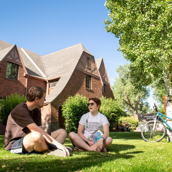 students chatting in the grass