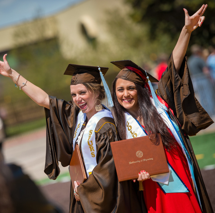 two students celebrating graduation