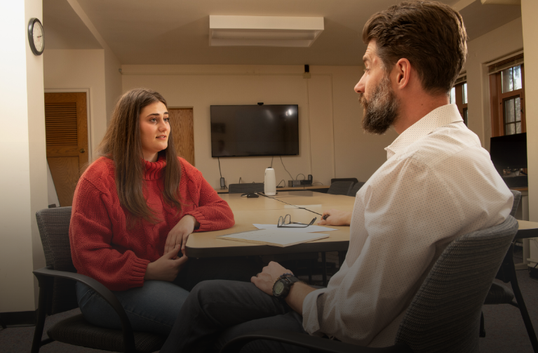 Academic advisor helping student in office