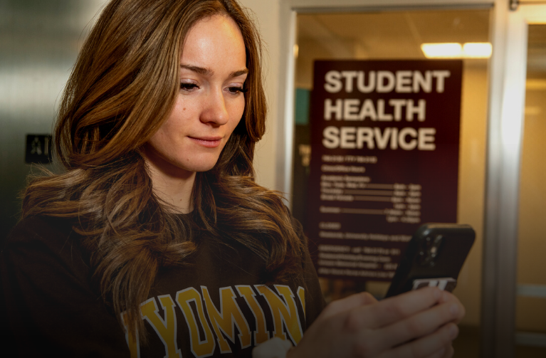 Student on phone outside of student health