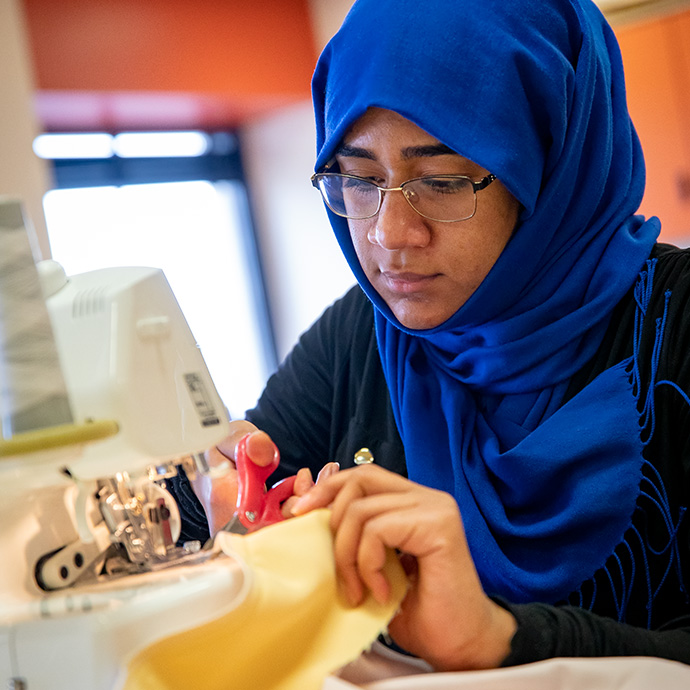 Student working on sewing machine