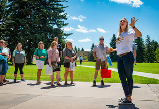 A UW staff member leads a group tour of the University of Wyoming campus.
