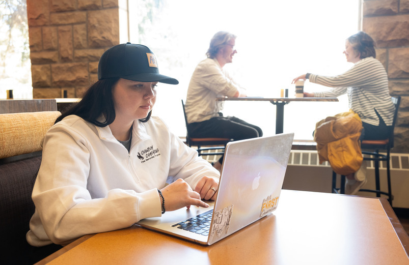 A UW student works on a computer as part of UW’s online education program.