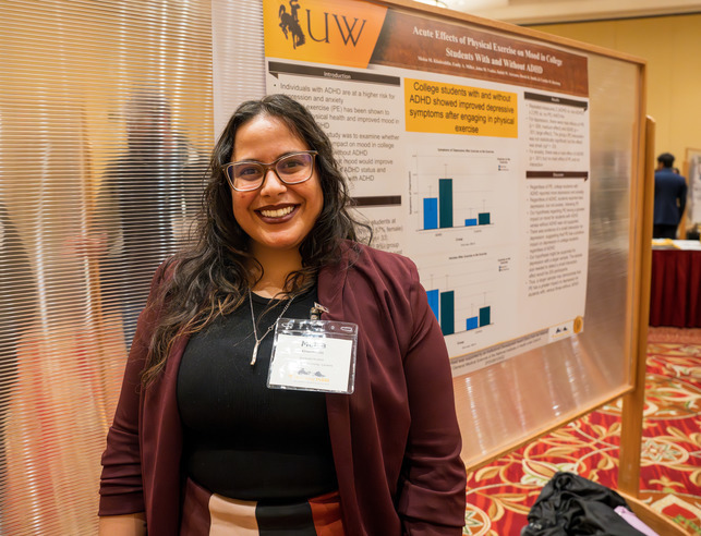 student in front of a presentation board