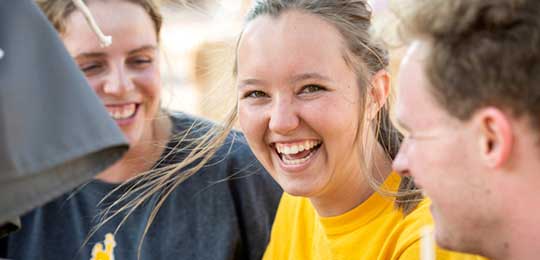 Three students on campus. Link to the University of Wyoming admissions page.