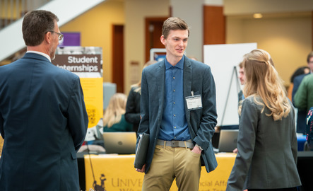 A student talks with businesses at Career Fair