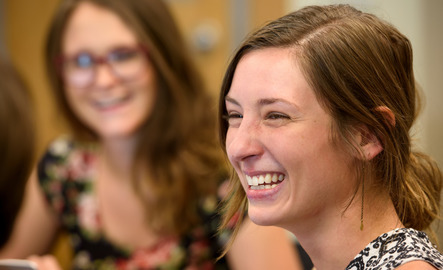 Student smiles in a group setting.