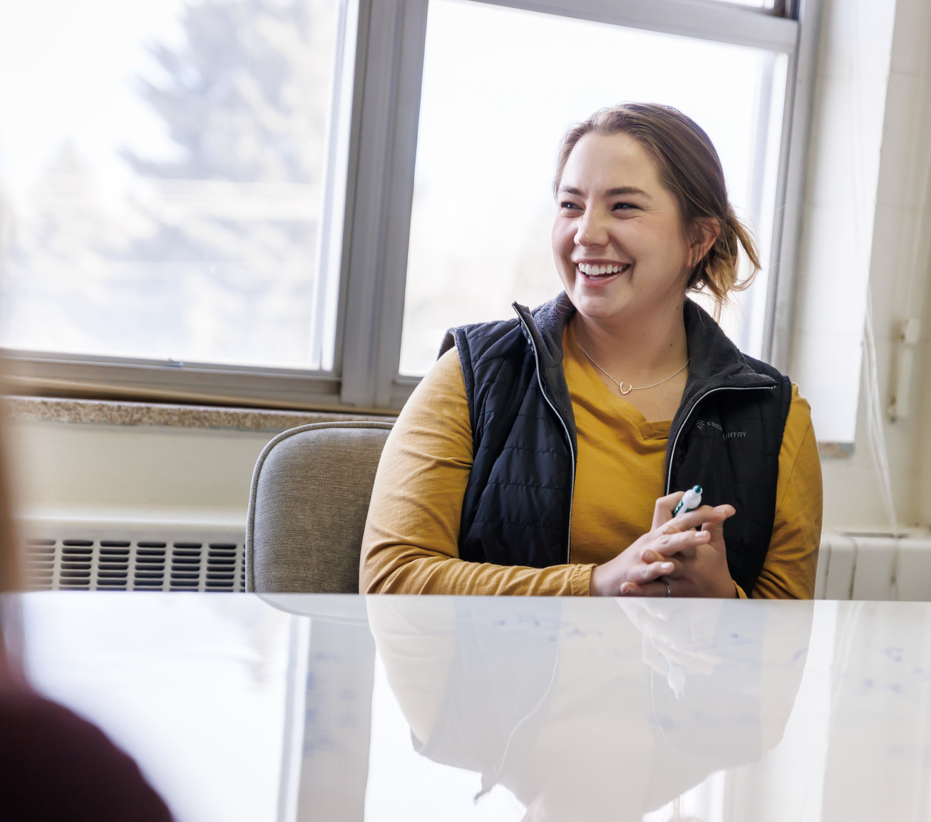 Student smiling with white board marker in her hand
