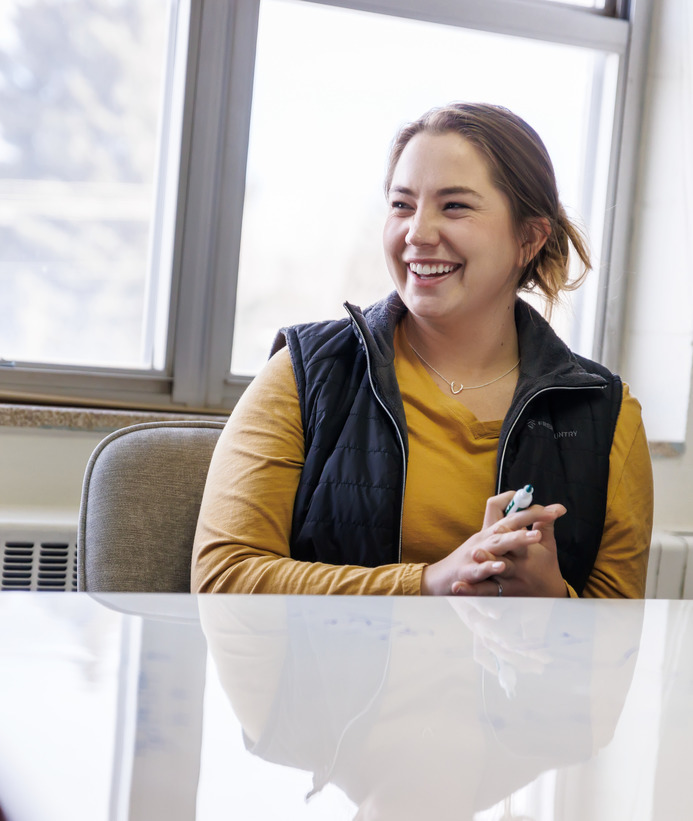 Student smiling with white board marker in hand