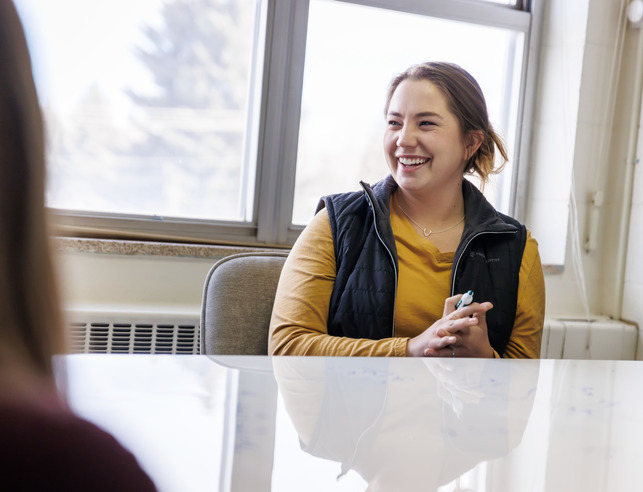 Student smiling with white board marker in hand