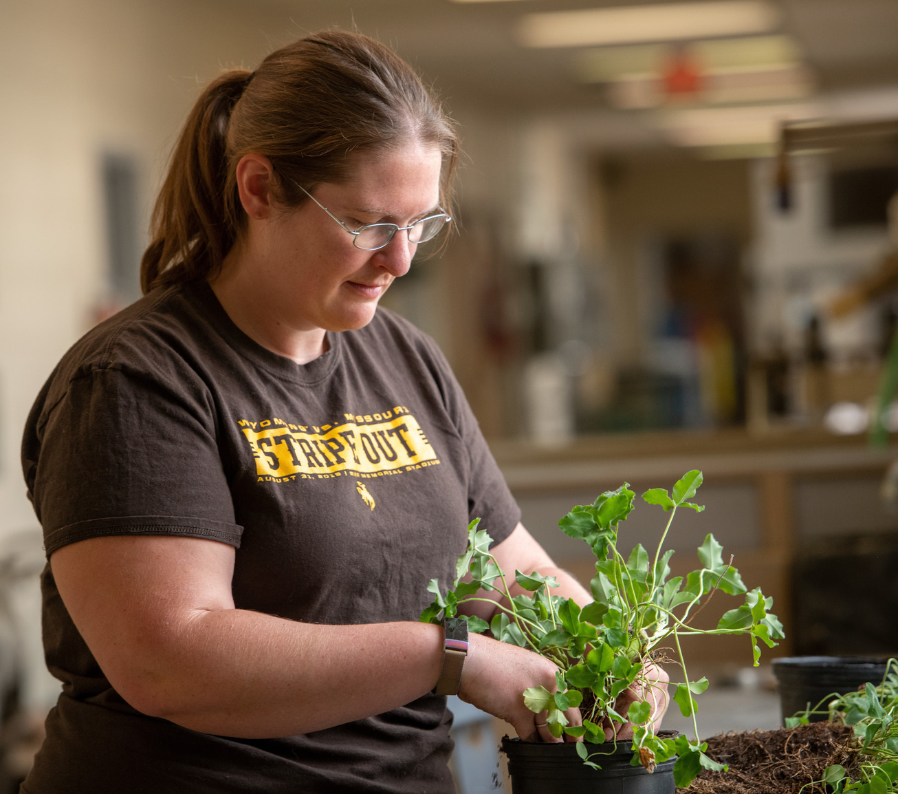 A student plants a plant