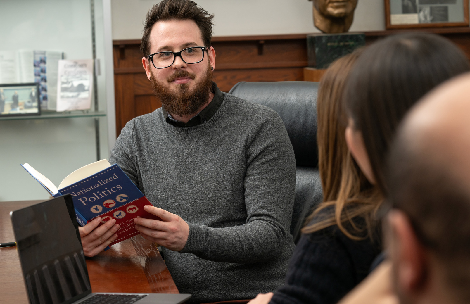 Student reading textbook in class