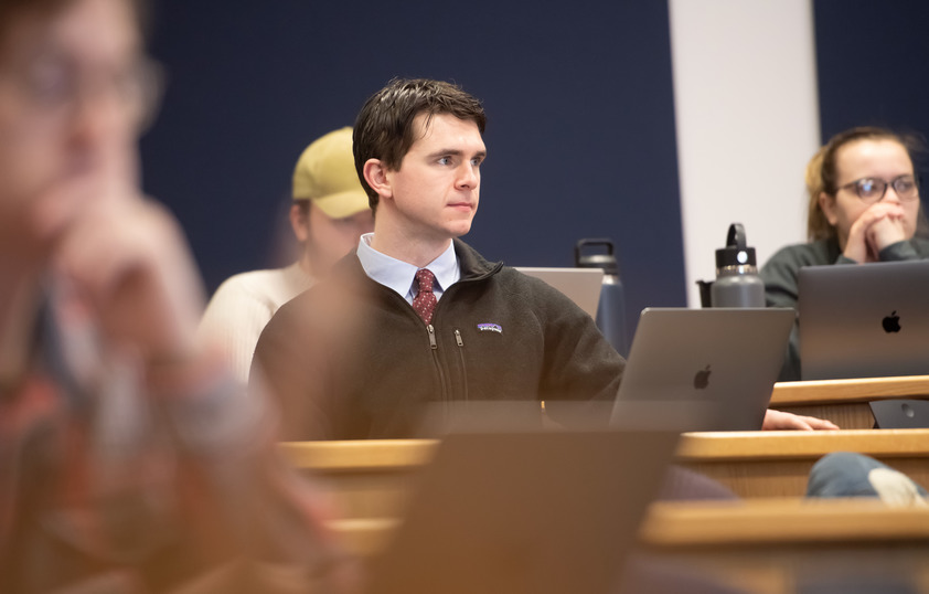 A student sits in a classroom listening to instruction.