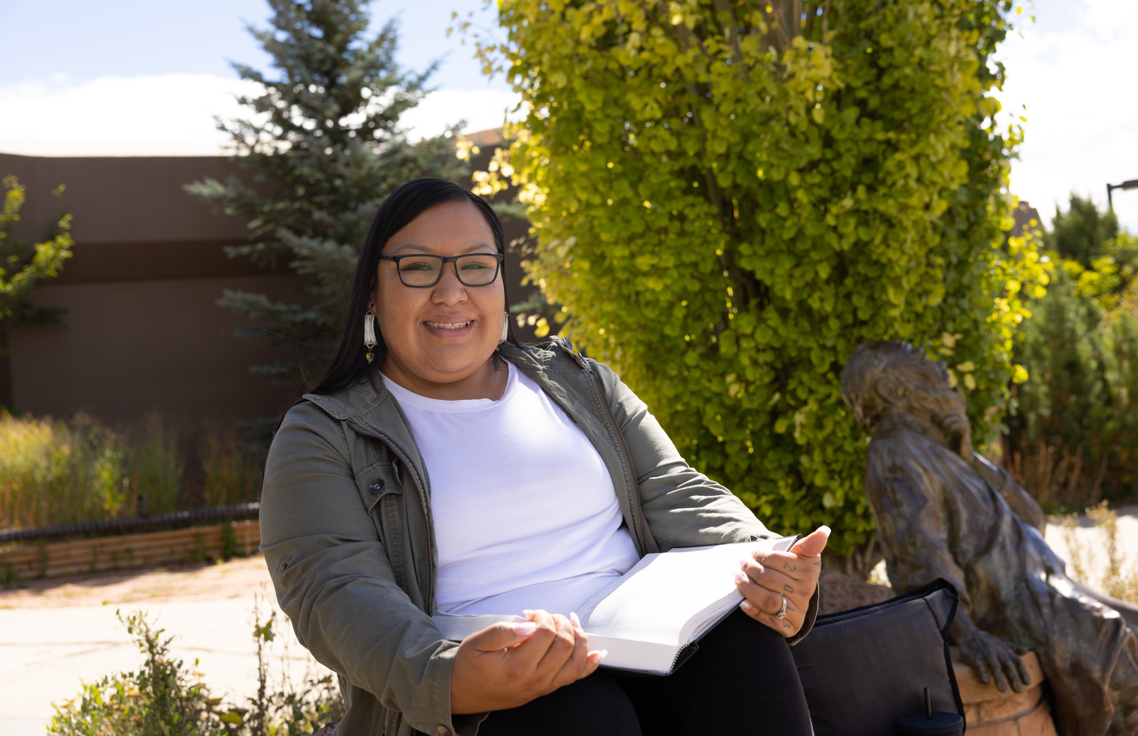 A student reads a book outside