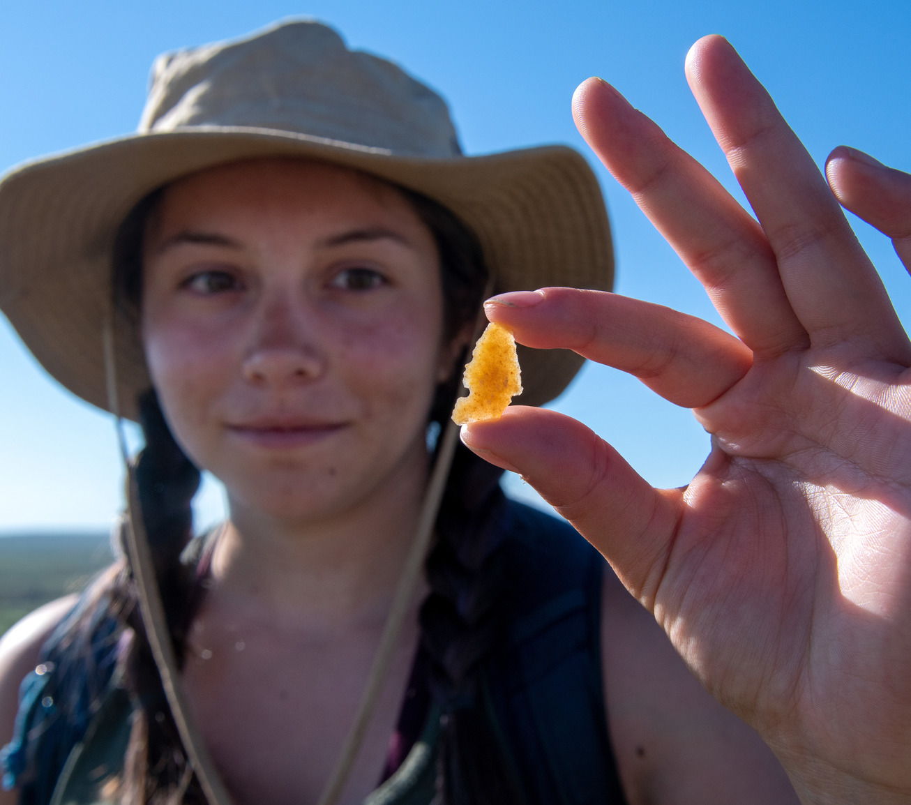 Student holding up arrow head